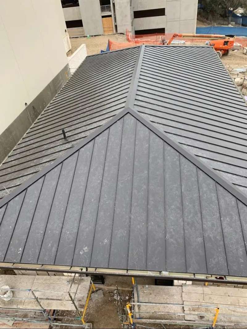 Commercial metal roof construction with crane equipment in Forest Acres
